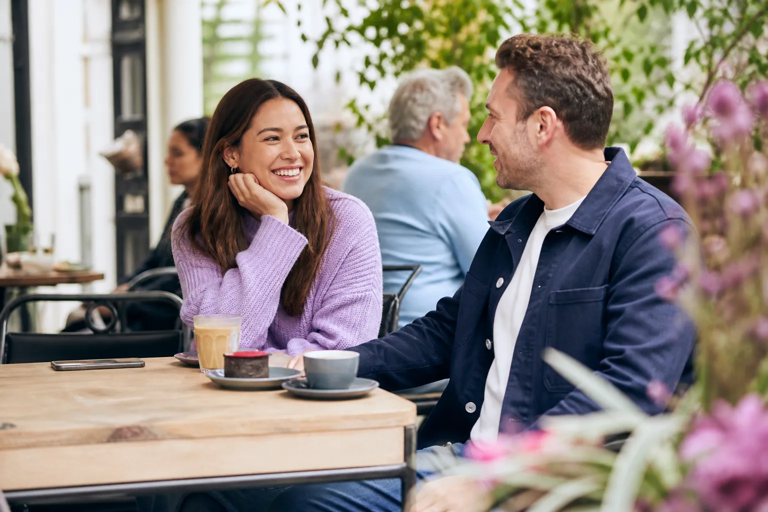 Two people chatting at an outdoor cafe in Adelaide on a Saturday