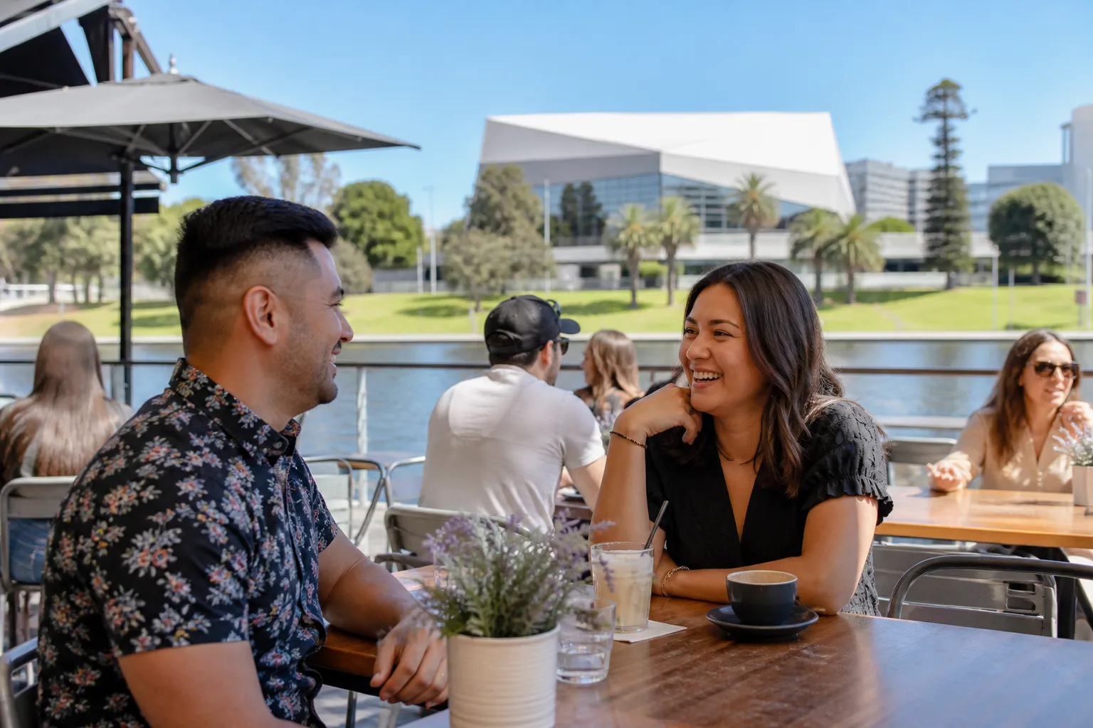Two people talking over coffee in Adelaide city