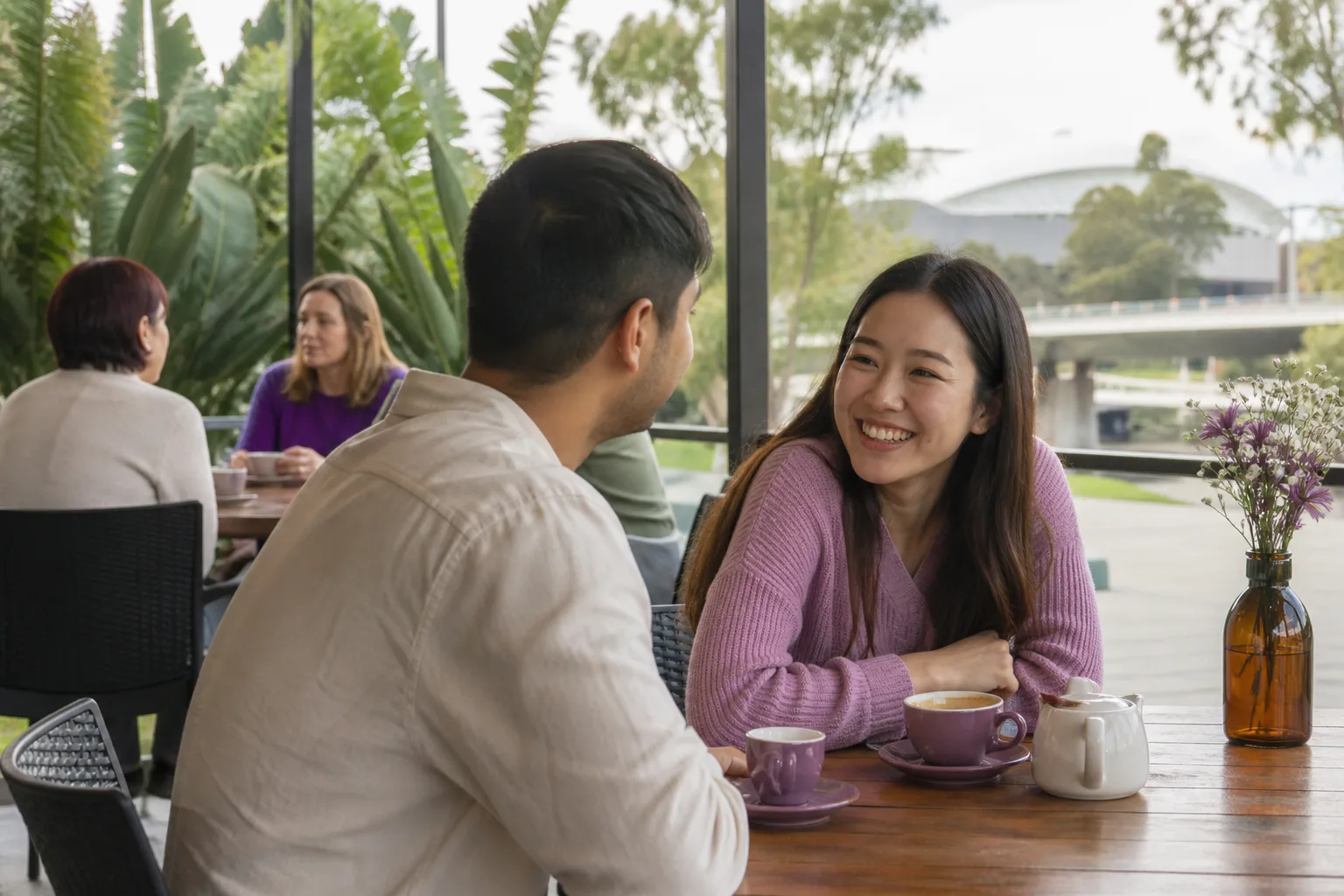 Two people talking beside the River Torrens in central Adelaide